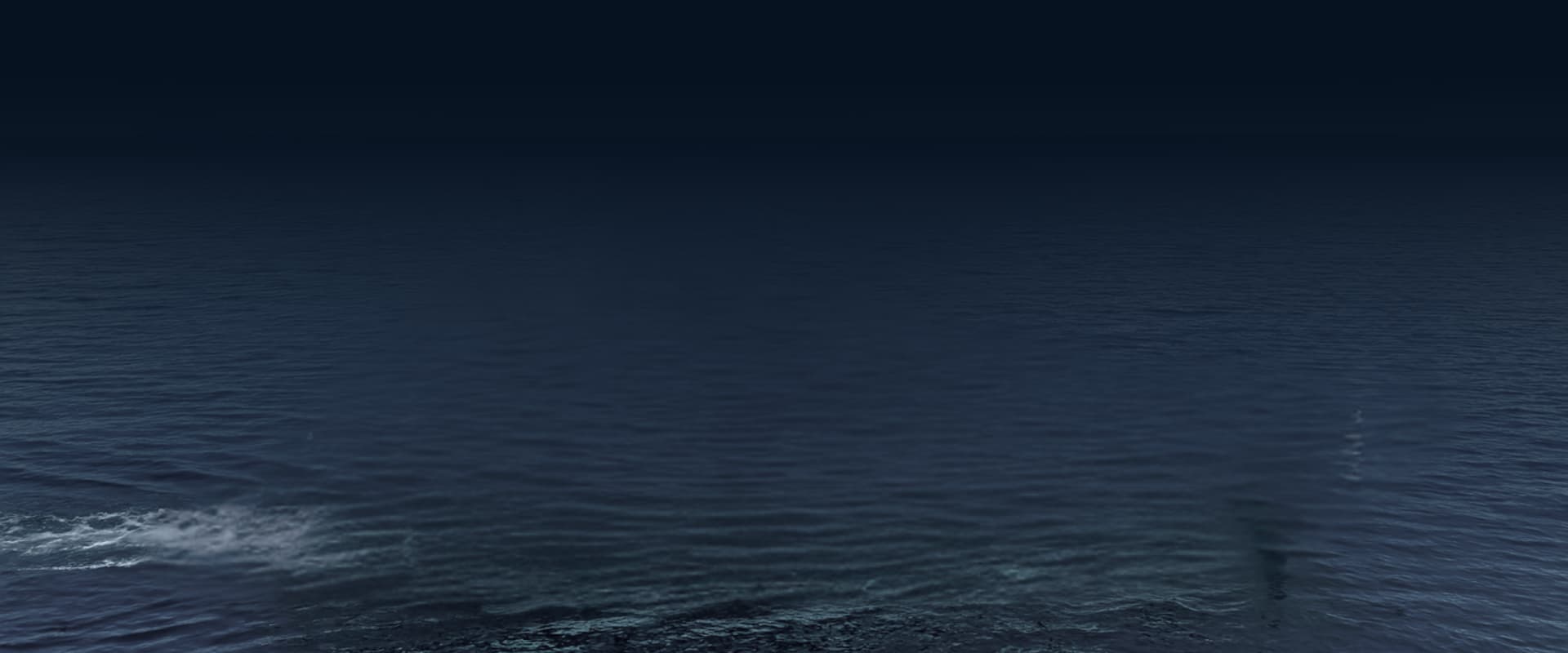 Yacht gliding through the ocean at dusk